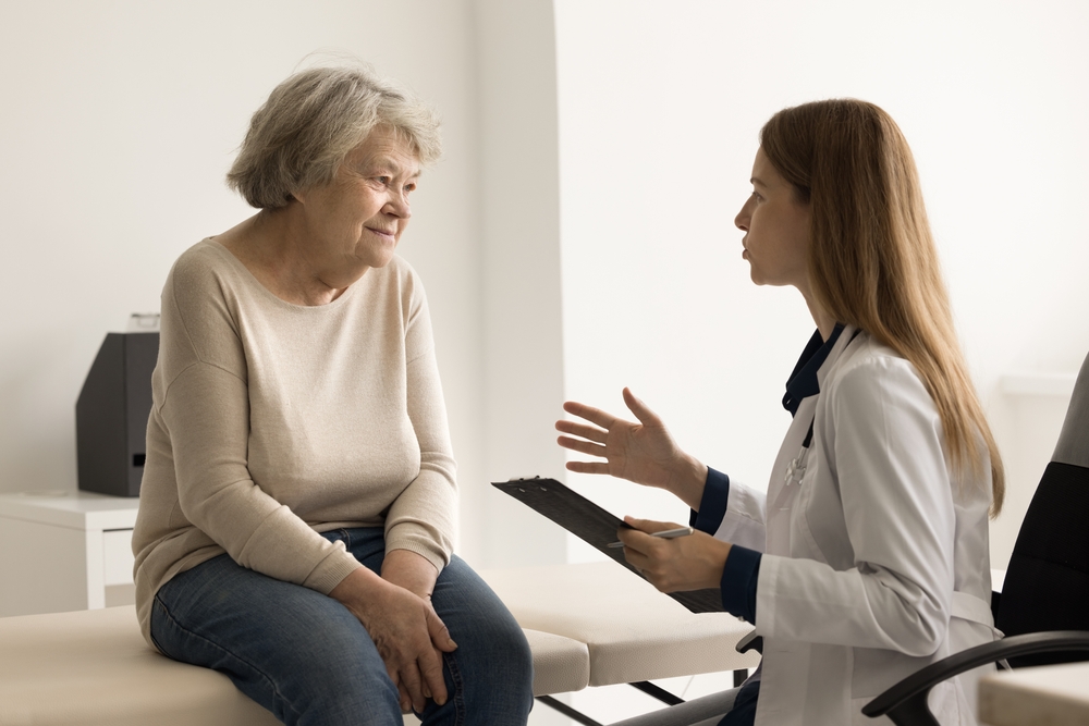 NP talking with older woman patient