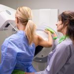 Radiographer,Preparing,Female,Client,For,Digital,Breast,Tomosynthesis