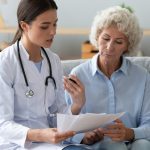 NP discussing vaccines with older patient