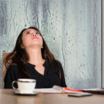 woman with migraine on a rainy day