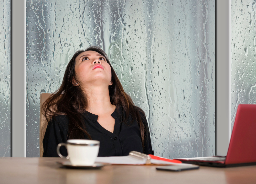 woman with migraine on a rainy day