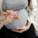 Pregnant woman with Vitamin D pill