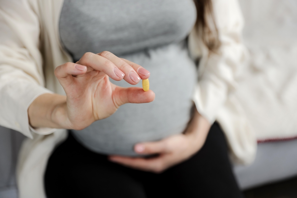 Pregnant woman with Vitamin D pill