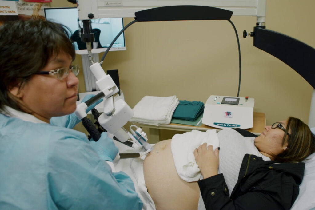 Technician Shawna Piche assists patient Trina Lobillard as she receives a remotely controlled ultrasound in 2018 in Stony Rapids, Saskatchewan. (Virtual Health Hub)