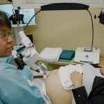Technician Shawna Piche assists patient Trina Lobillard as she receives a remotely controlled ultrasound in 2018 in Stony Rapids, Saskatchewan. (Virtual Health Hub)